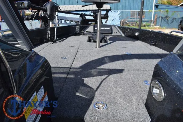 Slide: The Image of 2024 Triton 206 Allure boat deck with carpeted surface and seating. - 15