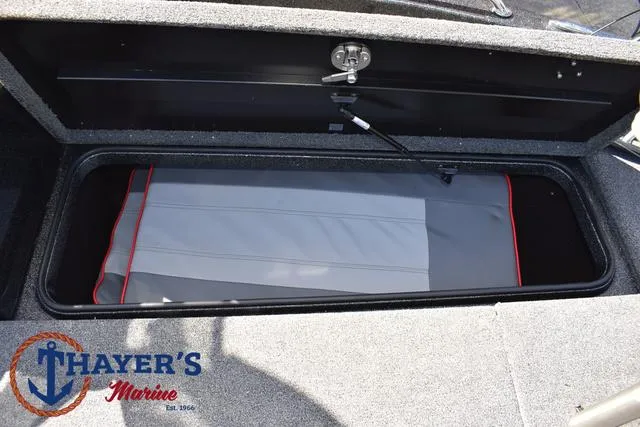 Slide: The Image of 2024 Triton 206 Allure boat storage compartment, Thayer's Marine logo visible. - 16