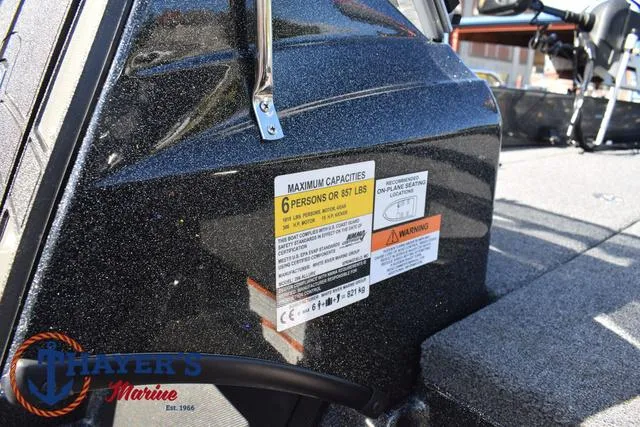 Slide: The Image of 2024 Triton 206 Allure boat capacity label, seating for 6, Thayer's Marine logo visible. - 25