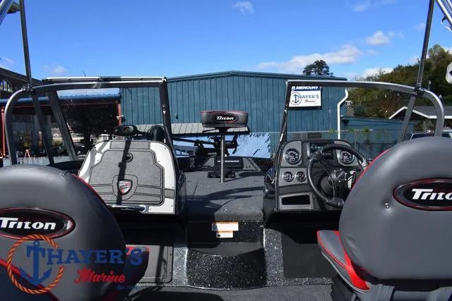 Slide: The Image of 2024 Triton 206 Allure boat interior with steering console and seating at Thayer's Marine. - 29