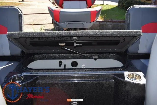 Slide: The Image of 2024 Triton 206 Allure boat interior with open storage compartment and seating. - 34