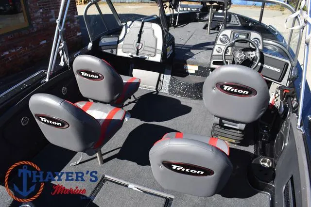 Slide: The Image of 2024 Triton 206 Allure boat interior with branded seats and modern dashboard. - 41