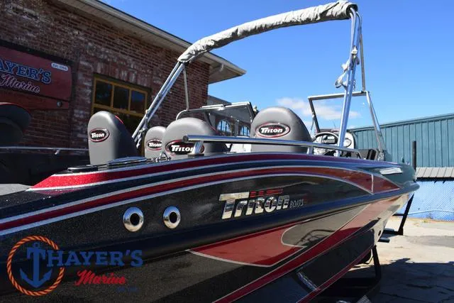 Slide: The Image of 2024 Triton 206 Allure boat at Thayer's Marine, featuring sleek design and vibrant colors. - 42
