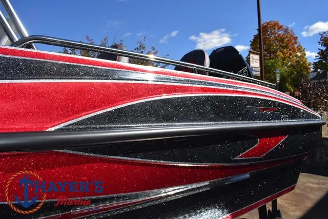 Slide: The Image of 2024 Triton 206 Allure boat with red and black design at Thayer's Marine. - 43