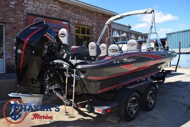 Slide: The Image of 2024 Triton 206 Allure boat with sleek design and powerful engine at Thayer's Marine. - 46