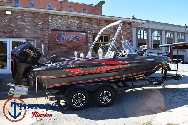 Slide: The Image of 2024 Triton 206 Allure boat at Thayer's Marine dealership. - 47