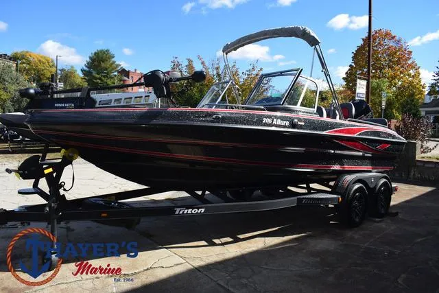 Slide: The Image of 2024 Triton 206 Allure boat on trailer at Thayer's Marine dealership. - 8