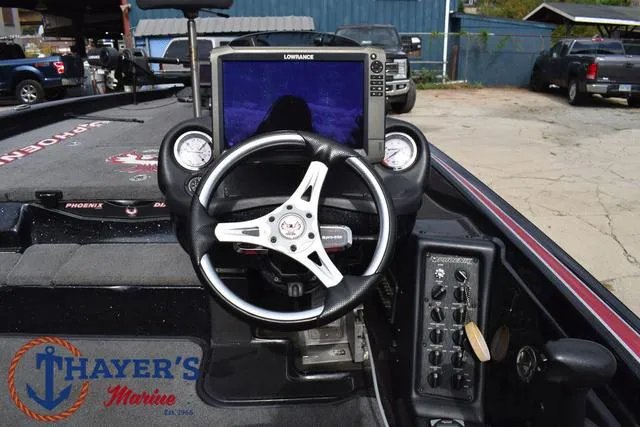 Slide: The Image of 2017 Phoenix Bass Boats 920 ProXP dashboard with steering wheel and Lowrance display. - 28