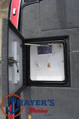 Slide: The Image of Open storage compartment on 2017 Phoenix Bass Boats 920 ProXP, featuring Thayer's Marine logo. - 34