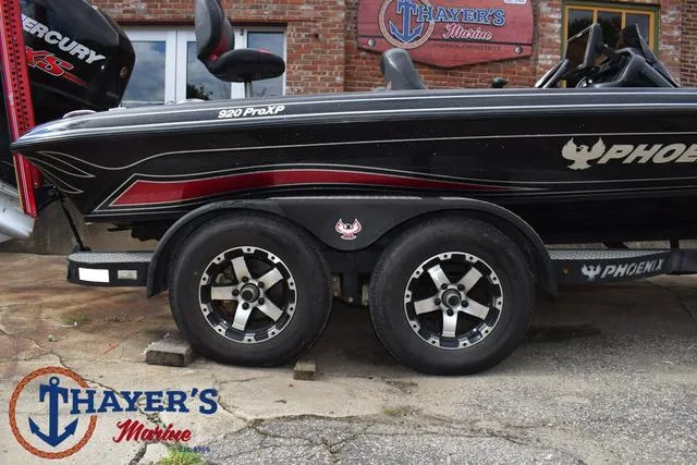 Slide: The Image of 2017 Phoenix Bass Boats 920 ProXP at Thayer's Marine, featuring sleek design and dual wheels. - 6