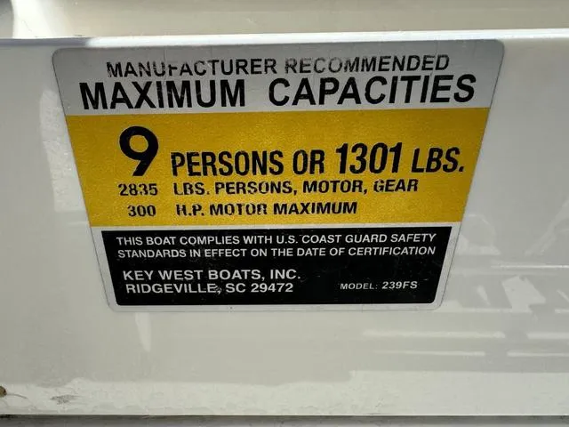 Slide: The Image of Key West 239FS 2022 boat capacity label: 9 persons or 1301 lbs, 300 HP max. - 13