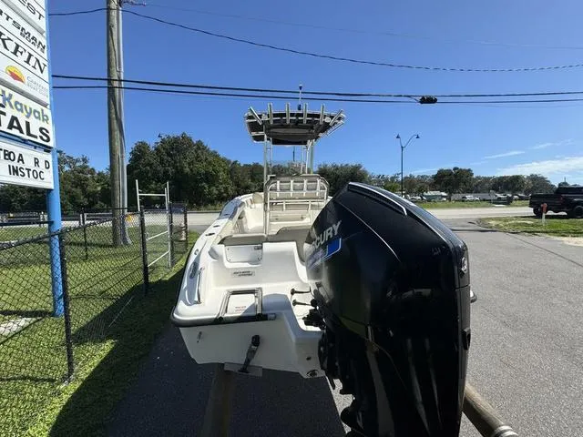 Slide: The Image of 2022 Key West 239FS boat with Mercury engine, parked outdoors on a sunny day. - 5