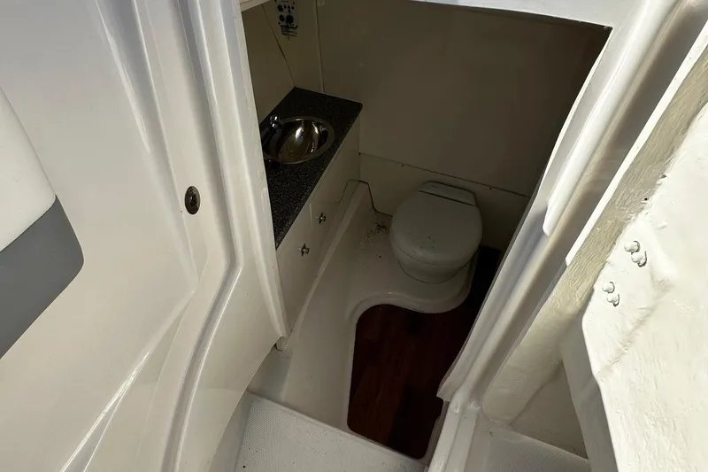 Slide: The Image of 2022 Robalo R317 Dual Console boat bathroom with sink and toilet. - 21