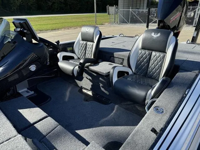 Slide: The Image of 2025 Phoenix 721 ZXL boat interior with two black and gray seats, steering console visible. - 14
