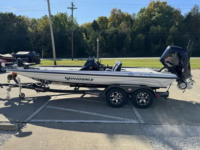 Slide: The Image of 2025 Phoenix 721 ZXL boat on trailer, parked outdoors. - 16