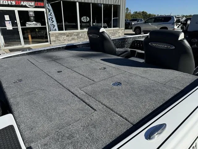 Slide: The Image of 2025 Phoenix 721 ZXL boat with spacious deck at a marine dealership. - 4