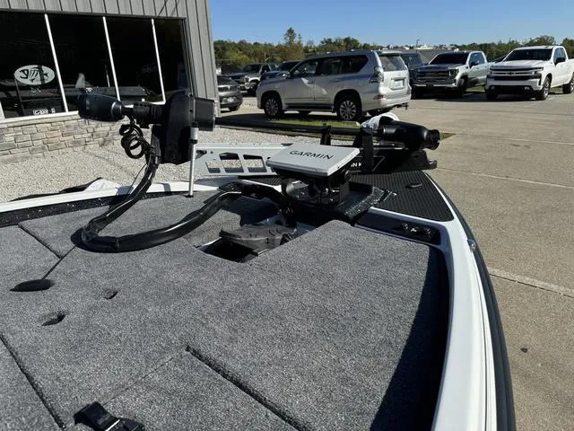 Slide: The Image of 2025 Phoenix 721 ZXL boat with Garmin equipment, parked outdoors near vehicles. - 6