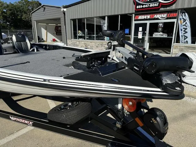 Slide: The Image of 2025 Phoenix 721 ZXL bass boat displayed at a marine dealership. - 8