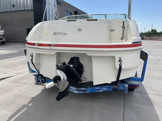 Slide: The Image of 2001 Rinker 243 Siesta DB boat on trailer, rear view, outdoor setting. - 4