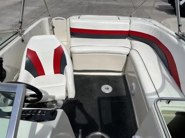 Slide: The Image of 2001 Rinker 243 Siesta DB boat interior with white, red, and black seating. - 5