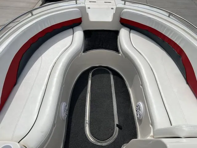 Slide: The Image of 2001 Rinker 243 Siesta DB boat interior with white and red seating. - 6