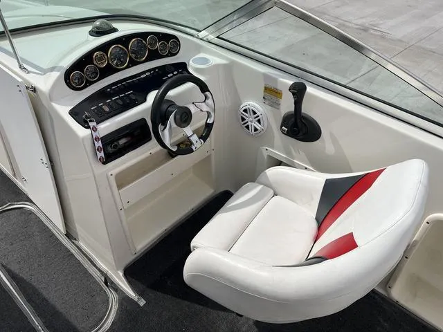 Slide: The Image of 2001 Rinker 243 Siesta DB boat cockpit with steering wheel and control panel. - 8