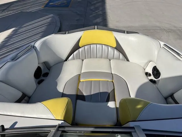 Slide: The Image of 2015 MB SPORTS B52 23 boat interior with gray and yellow seating. - 10