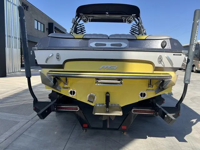 Slide: The Image of 2015 MB SPORTS B52 23 boat, yellow and black, rear view on concrete surface. - 7