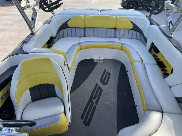 Slide: The Image of 2015 MB SPORTS B52 23 boat interior with yellow and gray seating. - 8