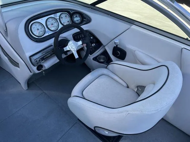 Slide: The Image of 2008 Supreme V232 boat interior with steering wheel and dashboard gauges. - 10