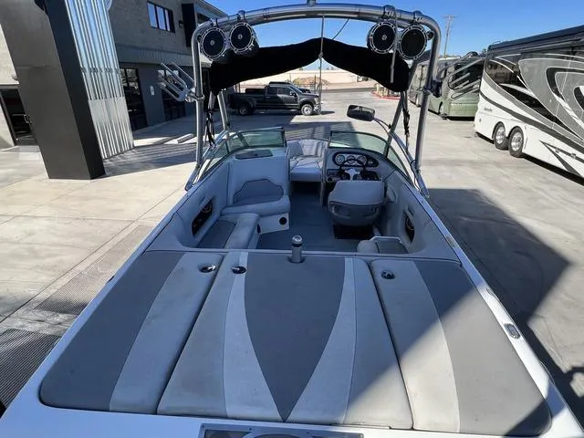 Slide: The Image of 2008 Supreme V232 boat interior with seating and speakers, parked outdoors. - 11