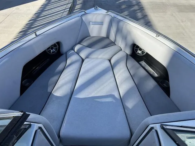 Slide: The Image of 2008 Supreme V232 boat interior with cushioned seating and built-in speakers. - 9