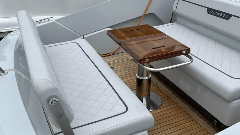 Slide: The Image of Luxury seating area on 2022 Fairline F//Line 33 yacht with wooden table and cushioned benches. - 27