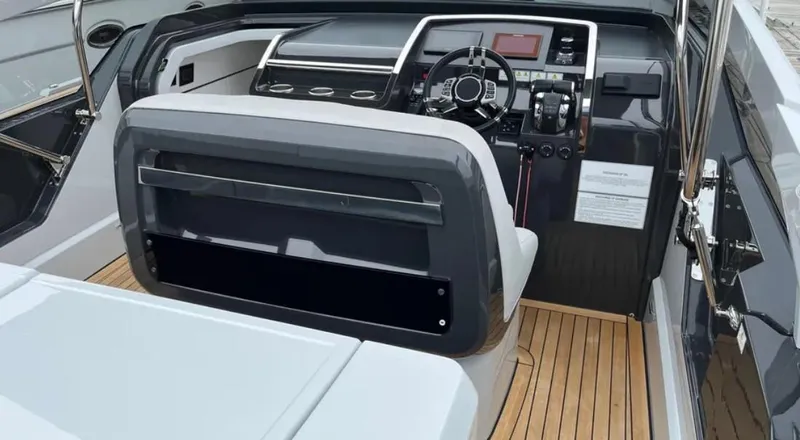 Slide: The Image of Cockpit of 2022 Fairline F//Line 33 yacht with modern controls and wooden flooring. - 31
