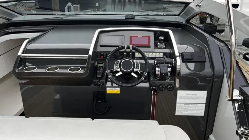 Slide: The Image of Cockpit of 2022 Fairline F//Line 33 yacht with modern steering and controls. - 36
