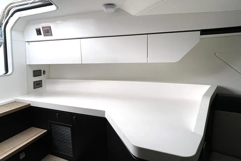 Slide: The Image of Interior of 2022 Fairline F//Line 33 yacht, featuring sleek white cabinetry and modern design. - 40
