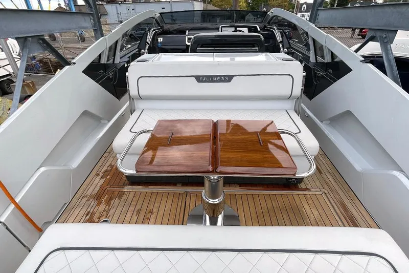 Slide: The Image of 2022 Fairline F//Line 33 yacht interior with sleek wooden table and seating. - 46
