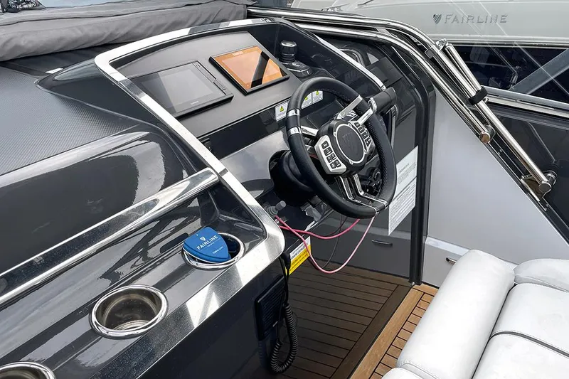 Slide: The Image of 2022 Fairline F//Line 33 yacht helm with modern controls and sleek design. - 49