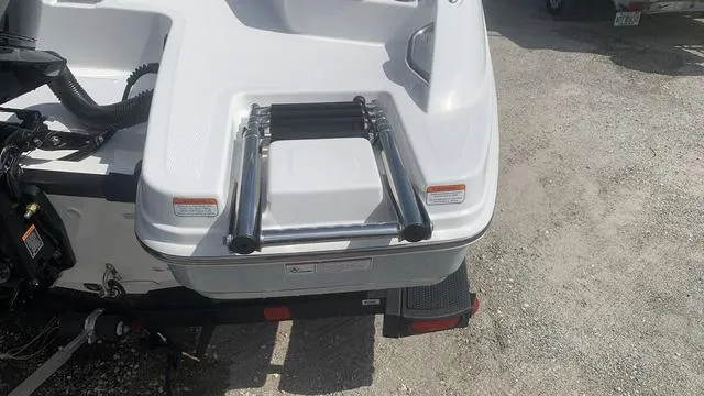 Slide: The Image of 2024 Tahoe 210 S boat with rear swim platform and ladder. - 11