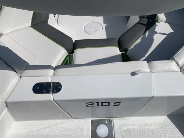Slide: The Image of 2024 Tahoe 210 S boat interior with white seating and green accents. - 12