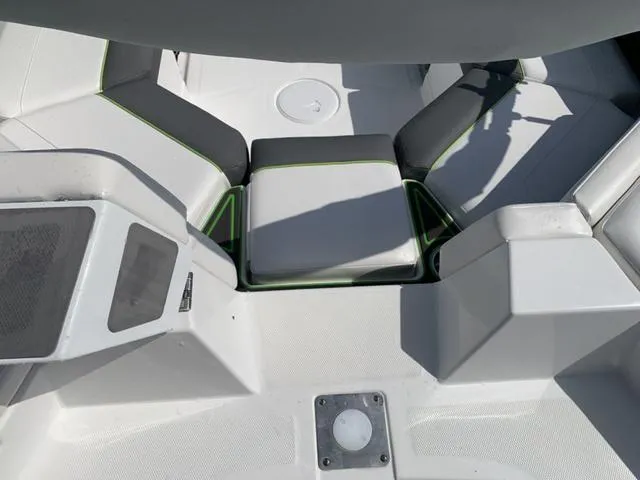 Slide: The Image of 2024 Tahoe 210 S boat interior with white and gray seating, green accents. - 13