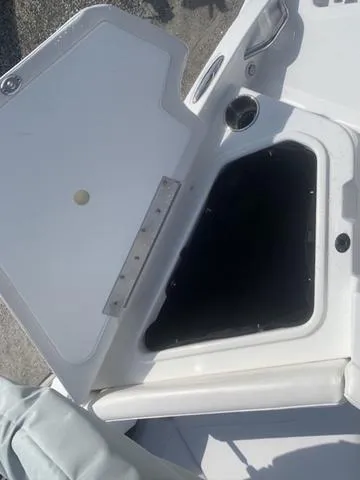 Slide: The Image of Open storage compartment on 2024 Tahoe 210 S boat deck. - 15