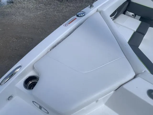 Slide: The Image of 2024 Tahoe 210 S boat interior with white seating and cup holders. - 16