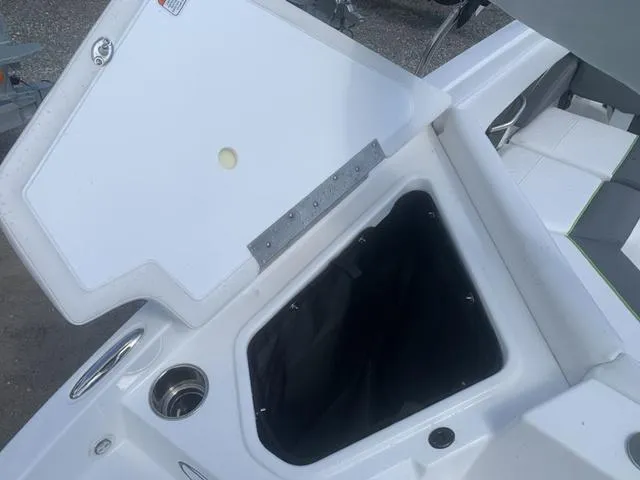 Slide: The Image of 2024 Tahoe 210 S boat storage compartment with open lid. - 17