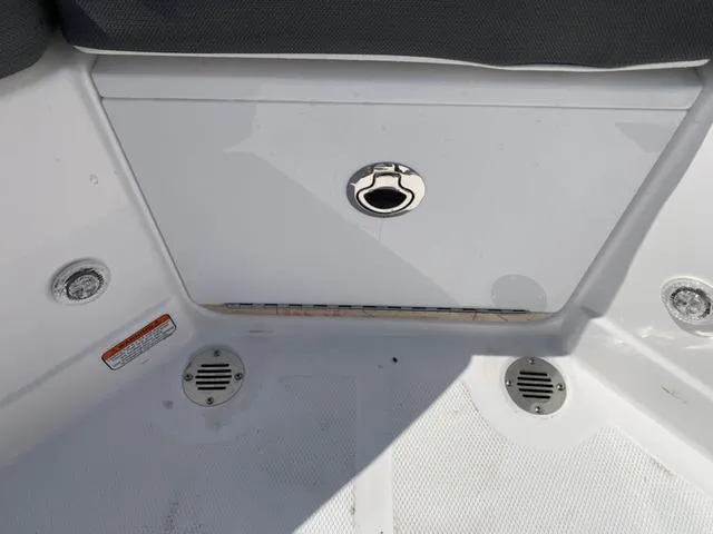 Slide: The Image of 2024 Tahoe 210 S boat interior with storage compartment and drainage features. - 25