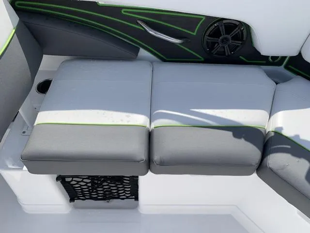 Slide: The Image of 2024 Tahoe 210 S boat interior with gray and green seating and speaker. - 27