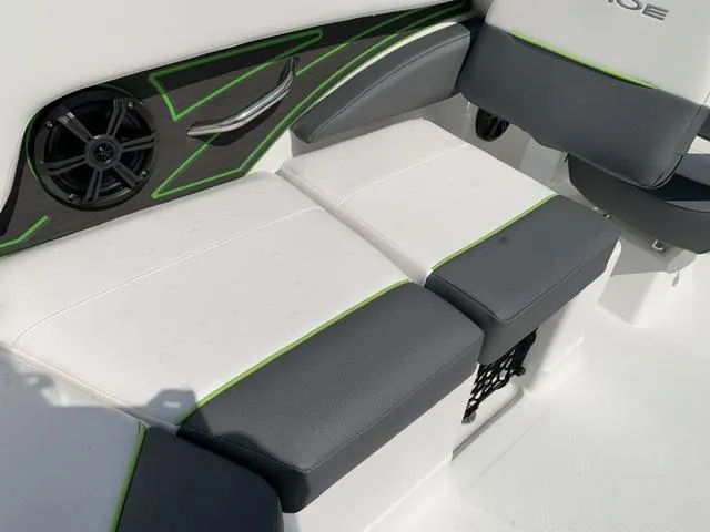 Slide: The Image of 2024 Tahoe 210 S boat interior with gray and white seating, green accents, and speaker. - 29