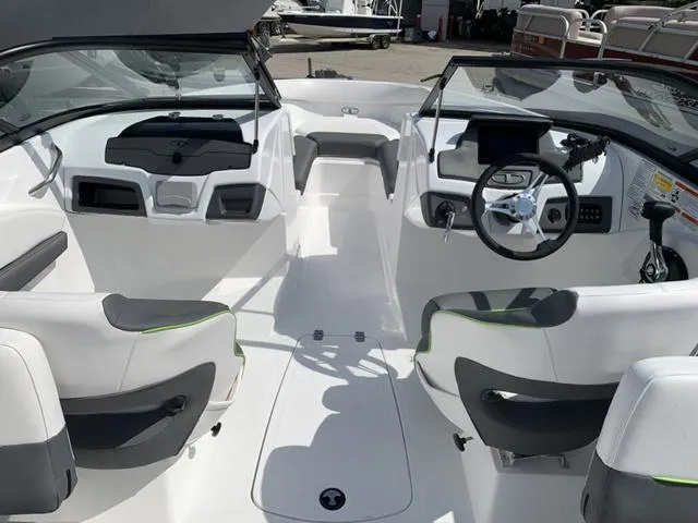 Slide: The Image of 2024 Tahoe 210 S boat interior with modern seating and steering console. - 31