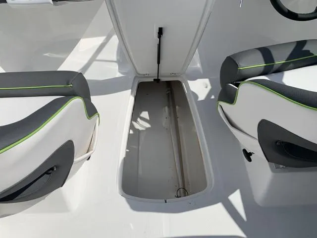 Slide: The Image of 2024 Tahoe 210 S boat interior storage compartment between seats. - 33