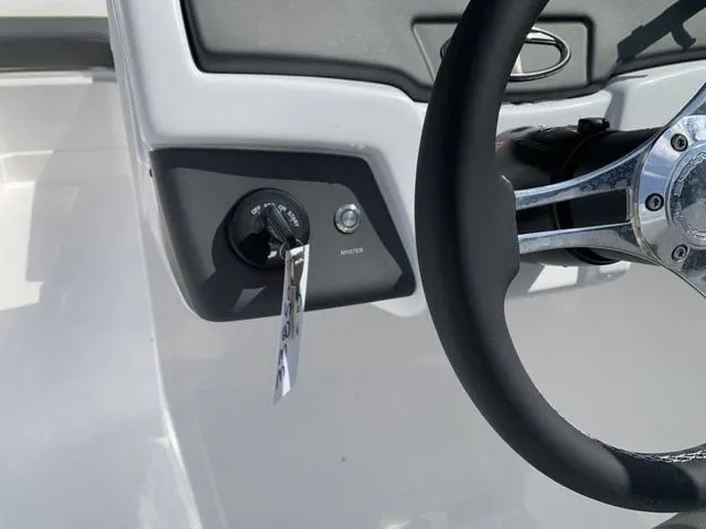 Slide: The Image of 2024 Tahoe 210 S boat steering wheel and ignition key close-up. - 36